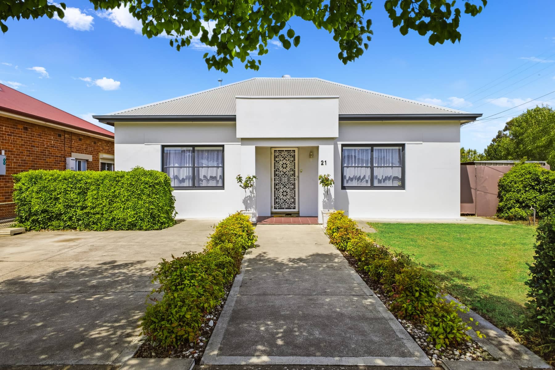 Daylight real estate photography — white villa facade with manicured garden, Adelaide