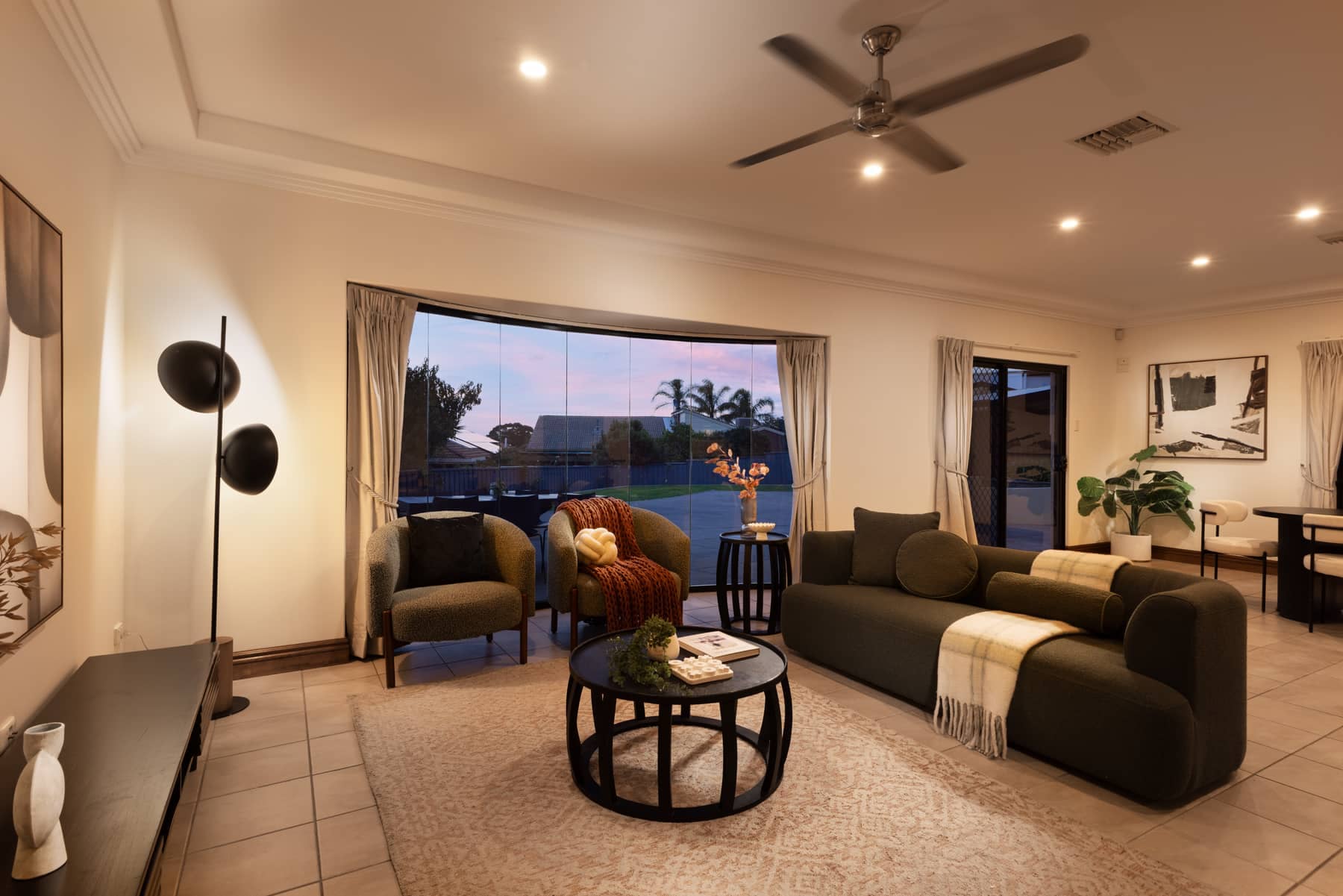 Signature real estate photography — styled living room lit for evening, 5 Welkin Court